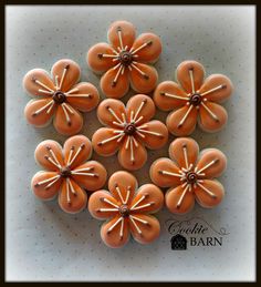 an arrangement of orange flowers on a white surface