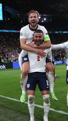 two soccer players are hugging each other on the field