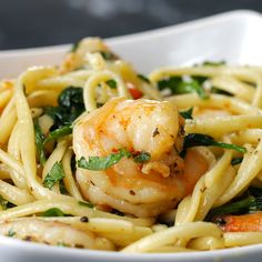 a white bowl filled with pasta and shrimp