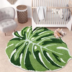 a baby's room with a green rug and white crib in the background