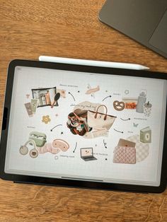 a tablet computer sitting on top of a wooden table next to a cup and pen