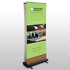 a roll - up banner stand with an image of farm animals and people on it