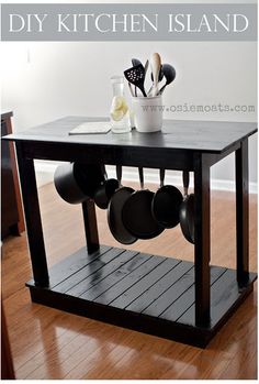 a kitchen island with pots and pans on it in the middle of a room