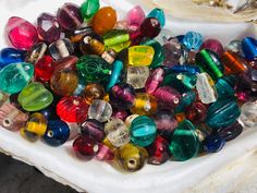 a bowl filled with lots of colorful glass beads