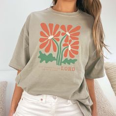 Show your gratitude to the Lord with this comfortable and stylish tee! Made from high quality materials, it showcases the message "Give Thanks to the Lord" with floral art deco print. Spread positivity and inspire others with this uplifting and meaningful shirt. Design is Printed Direct to Garment. See Size Guide for Comfort Color Unisex Tee We recommend comparing these measurements against a shirt that you like the fit of for ordering a tee that will fit best. Crafted Just for You: Our products are made to order, and we're all about delivering that extra touch of personalization. Expect an order confirmation email right after you shop, and then we'll hustle to get your order ready within 7 days. When it's time to ship, we'll send you a delightfully exciting email with tracking to keep you Inspirational Relaxed Fit T-shirt For Spring, Inspirational Graphic Print Tops For Summer, Inspirational Graphic Print Summer Tops, Inspirational Short Sleeve Tops For Spring, Give Thanks To The Lord, Art Deco Print, Spread Positivity, Order Confirmation, Comfort Colors Tee