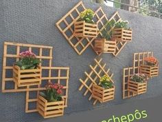 several wooden planters mounted to the side of a wall