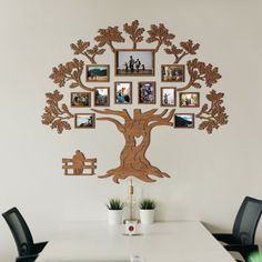 a family tree with pictures hanging on it's wall above a dining room table