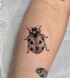 a ladybug tattoo on the left arm