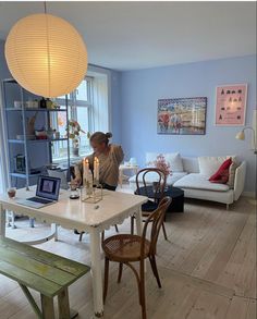 a woman sitting at a table in a living room