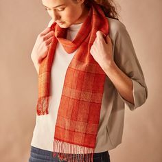 a woman is wearing an orange scarf