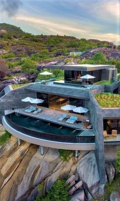 an aerial view of a house on top of a hill with grass growing on the roof