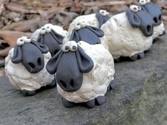 some fake sheep sitting on top of a rock