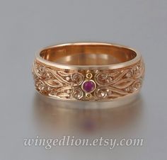 "Inspired by Renaissance art, this lavishly ornamented band was designed and crafted by the artist and jewelry designer Sergey Zhiboedov (my husband). The ring will be made to order in 14K rose gold in the size specified by the customer.  The PRINCE CHARMING band is 7.5mm wide and adorned with intricate carvings. It features a 2mm natural ruby. The antique tarnishing (black rhodium plating) adds depth and brings out the beautiful pattern. Please select the finish you prefer - with or without tar Gold Mens Wedding Band, Rose Gold Mens Wedding Band, Intricate Rings, Interesting Jewelry, Mens Gold Wedding Band, Sapphire Band, Gold And Silver Rings, Ring Ideas, Funky Jewelry