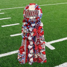 a football themed bow on the sideline of a field with an american flag in the background