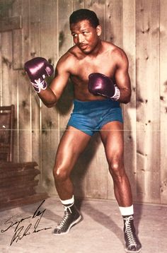 an old photo of a man wearing boxing gloves