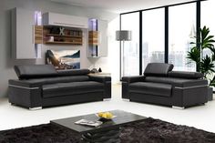 a modern living room with black leather furniture