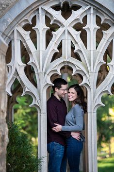 a man and woman standing in an archway