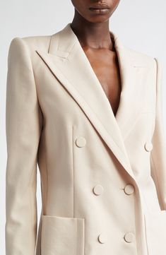 The silhouette-defining shoulders on this wool jacket exemplify the tailoring heritage that's a significant aspect of the Belgian designer's reputation. Sharply cut peaked lapels, precision topstitching and covered buttons on the double-breasted placket all contribute to the fitted, polished piece. 32" length (size 38 FR) Double-breasted button closure Peaked lapels Four-button cuffs Chest welt pocket; front patch pockets Lined 100% wool Dry clean Imported Designer Clothing Timeless Long Sleeve Blazer With Structured Boning, Luxury Outerwear With Structured Shoulders For Office, Luxury Office Outerwear With Structured Shoulders, Luxury Fall Blazer With Structured Shoulders, Luxury Blazer With Structured Shoulders For Fall, Elegant Beige Wool Blazer, Luxury Blazer With Structured Shoulders, Elegant Beige Suit With Double Button Closure, Elegant Cream Wool Blazer