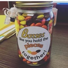 a jar filled with candy sitting on top of a wooden table