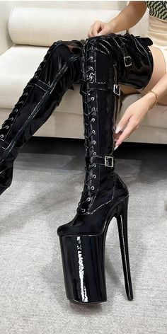 Elevate your style with these bold black platform boots, featuring striking lacing and ultra-high heels for a look that's both daring and sophisticated. Ideal for those who love statement footwear, these thigh-high boots combine avant-garde style with a modern edge, making them a standout addition to any fashion-forward wardrobe. Perfect for adding a touch of drama to your special events or nights out. High-cut Winter Party Boots, Winter Party High-cut Platform Boots, Winter Party High Cut Platform Boots, High Cut Platform Boots For Fall Night Out, High Cut Platform Boots For Night Out In Fall, Chic High-cut Heeled Boots For Party, High Cut Heeled Boots For Fall Party, Chic High Cut Heeled Boots For Party, Party High Cut Platform Heeled Boots