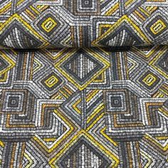 a close up view of a tie with yellow and grey designs