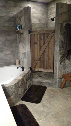 a large bathroom with stone walls and flooring