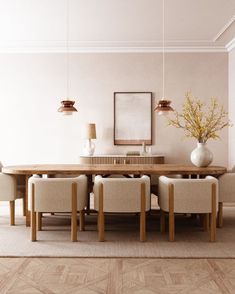 a dining room table with chairs and a vase filled with flowers