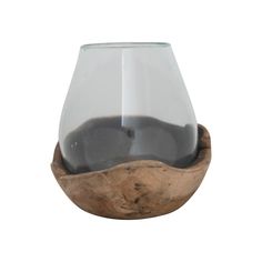 a wooden bowl filled with black liquid on top of a white background