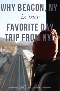 a woman looking out the window at a train track and mountains with text that reads why beacon, ny is our favorite day trip from nyc