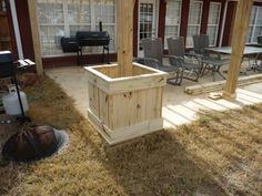 a wooden planter sitting in the middle of a yard