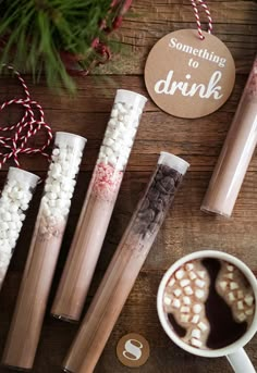 some hot chocolate sticks and marshmallows on a table