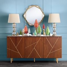 a buffet table with two lamps and a mirror above it that says world market on the wall