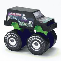 a black monster truck with green wheels and skulls on it