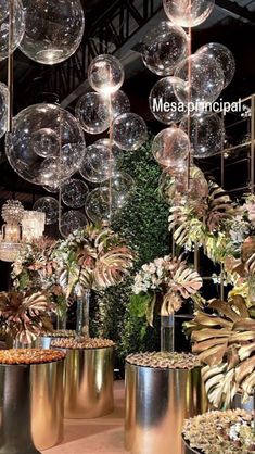 a room filled with lots of different types of vases and plants on display in front of hanging bubbles