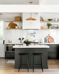 two stools are in front of the kitchen island