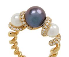 Inspired by the open sea and days spent by the ocean, this Boochier ring is a statement-making take on the traditional cocktail ring. The center gray freshwater pearl is set between two smaller white freshwater pearls at the center of the tapered, 18K yellow gold slinkee band. The four slinkee segments that separate the pearls are covered in shimmering white diamonds. gray freshwater pearl : 9mm diameterwhite freshwater pearls : 6mm diameter eachdiamonds : about 1mm diameter each : .70cttw18K ye Luxury Yellow Gold Tahitian Pearl Ring, Luxury Tahitian Pearl Ring In Yellow Gold, Jewelry Facts, Daniela Villegas, Perfect Pearls, Twist Jewelry, Zoe Chicco, Cathy Waterman, By The Ocean