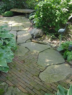 a brick path in the middle of a garden