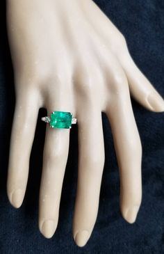 Gorgeous vintage platinum engagement ring gem natural green emerald in emerald shape Center emerald weight 4.47ct. size 10.6x8.5mm gorgeous green color nice luster very lively ,brilliant spakly and clean. side two natural diamonds total weight 0.20ct. J -SI1 ring size 7 Resizable Appraisal available Retail value $9,500 net. Gia Certified Formal Emerald Cut Emerald Ring, Formal Emerald Cut Emerald Ring With Vvs Clarity, Emerald Cut Emerald Ring With Vvs Clarity, Radiant Cut Emerald Ring With Vvs Clarity, Gia Certified Green Princess Cut Diamond Ring, Emerald Cut Emerald Ring In Fine Jewelry Style, Fine Jewelry Emerald Cut Emerald Ring, Green Diamond Ring With Vvs Clarity And Radiant Cut, Gia Certified Emerald Cut Diamond Ring