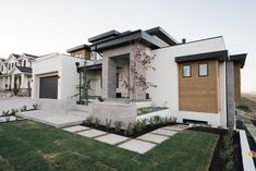 a modern house in the middle of a grassy area