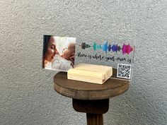 a wooden table topped with a piece of wood next to a photo on top of it