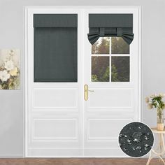 the front door is decorated with black curtains and white walls, along with an ornate vase filled with flowers