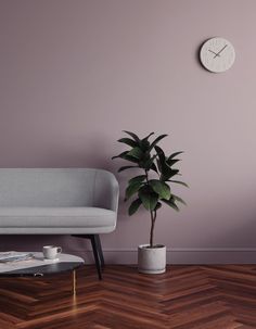 a living room with a couch, coffee table and clock on the wall