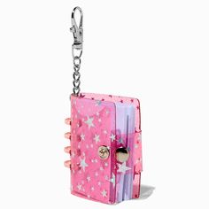 a pink and purple book shaped keychain with stars on the front, attached to a chain