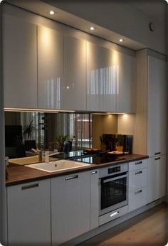 a kitchen with an oven, sink and cabinets on the wall in front of it