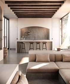 a living room filled with furniture next to a kitchen and dining area in front of a window