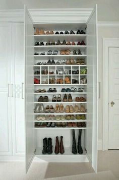 a white closet filled with lots of shoes