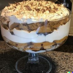 there is a cake on the table with frosting and toppings in it's glass dish