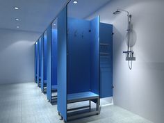 a row of blue stalls sitting next to each other in a room with white walls