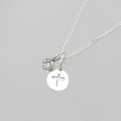 "Handcrafted sterling silver necklace with a stamped cross. Comes on your choice of a 16 or 18 inch sterling silver chain with the artist's tag attached at the clasp. (Shown on a 16\" chain) Makes an excellent gift. Can be worn a number of ways. Add more some birthstone drops for a more personal touch! To add a birthstone drop pendant, go to: https://www.etsy.com/listing/127617405/birthstone-drop-pendant-sterling-silver?ga_search_query=birthstone+drop+pendant&ref=shop_items_search_3" Inspirational Sterling Silver Nickel-free Charm Necklaces, Inspirational Sterling Silver Nickel-free Charm Necklace, Cross Necklace With Charms As Gift, Sterling Silver Cross Pendant Necklace With Charms, Sterling Silver Necklaces With Cross Pendant Charms, Dainty Sterling Silver Cross Pendant Charm Necklace, Spiritual Sterling Silver Hand Stamped Necklaces, Sterling Silver Charm Necklace With Cross Pendant, Sterling Silver Cross Charm Necklace