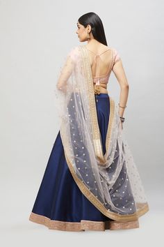 Customize your bridesmaids outfits today! This beautiful blush embroidered blouse contrasted with a navy blue A-line lehenga comes with a complementing blush dupatta! Fabric: Raw silk blouse and skirt, Net dupatta All custom orders will be handled by a Nazranaa Bridal Consultant who will virtually discuss measurements and minor changes according to the client's specifications Occasion: Wedding Ceremony Production time: 3.5-4.5 months Minimum order of 4 pieces WASH CARE INSTRUCTIONS - Please Dry Bridesmaids Lehenga, Bridesmaids Outfits, Raw Silk Blouse, Bridesmaid Lehenga, Bridal Consultant, Party Wear Lehenga, Bridesmaid Outfit, Net Dupatta, Todays Outfit